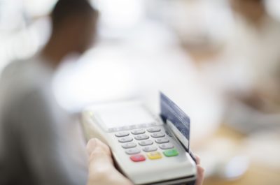 credit card being swiped through payment machine 521812387 57571d033df78c9b46b97f4f