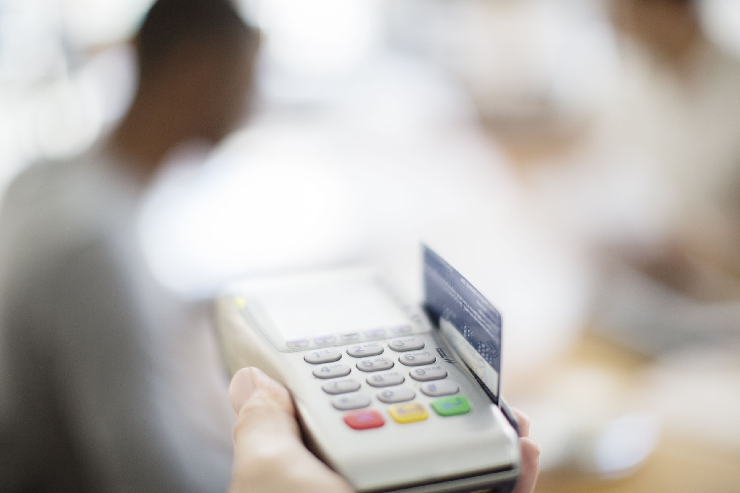 credit card being swiped through payment machine 521812387 57571d033df78c9b46b97f4f